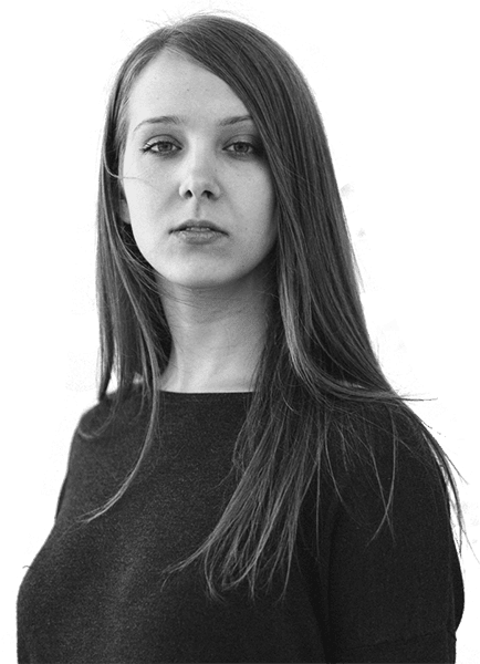 Black and white portrait of a serious young woman with long hair.